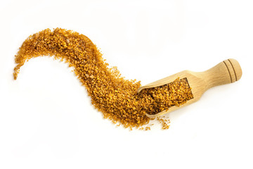 Scoop of brown sugar on white with copyspace, overhead shot