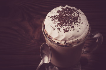 Hot viennese coffee with whipped cream on dark background