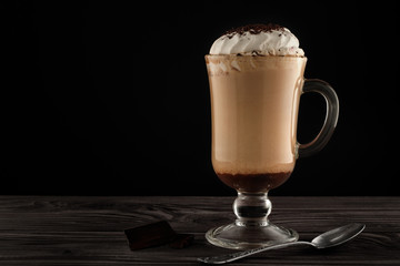 Hot viennese coffee with whipped cream on dark background