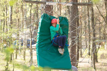 Gomel, Belarus - 30 April, 2017: Rope town for a family holiday in the countryside. Family competition to overcome aerial obstacles.