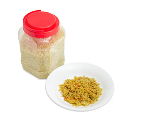 Cooked rice on dish and uncooked rice in plastic container