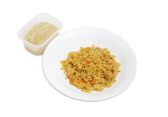 Cooked rice on dish and uncooked rice in plastic container