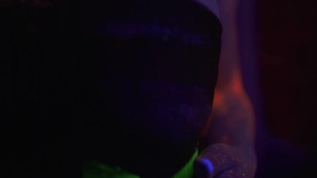 Closeup view of woman in fluorescent clothing under UV black light