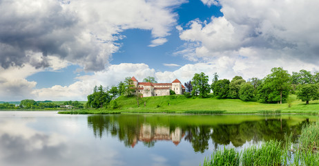 Fototapeta na wymiar Svirzh Castle on lake bank in Lviv region, Ukraine