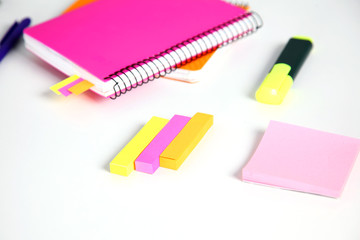colorful sticky bookmarks for Notebook, staplers and pen on white background. Selective focus.