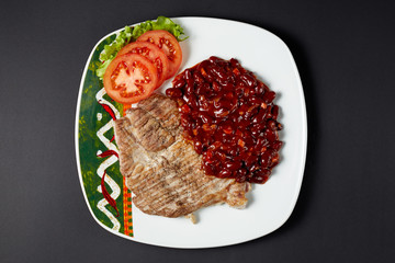 Pork steak with beans. Mexican food. Mexican cuisine.