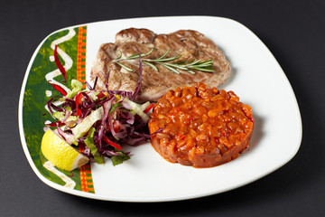 Pork steak with beans. Mexican food. Mexican cuisine.