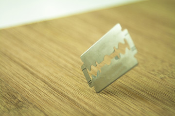 Razor blade over the wooden board
