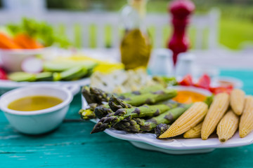 Pinzimonio - Vegetable appetizers with olive oil on a garden table