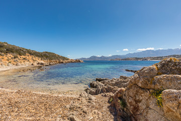 Fototapeta na wymiar Beach and and rocky coastline at Revellata in Corsica