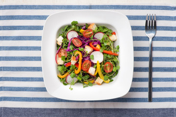 Homemade fresh green vegetable salad on table.