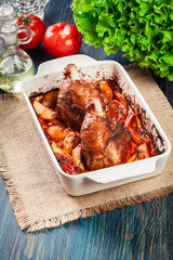 Roasted turkey knuckle with potatoes and vegetable