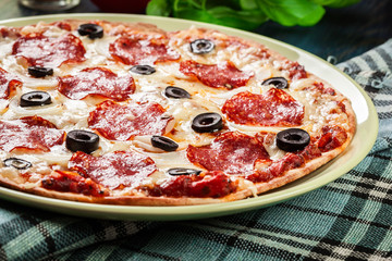 Pizza pepperoni with olives served