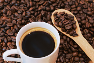 Coffee cup and coffee beans on table