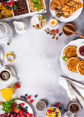 Healthy breakfast background with coffee, pancakes, fresh berries, quick cereals and orange juice, copy space, top view.
