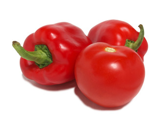 Red tomatoes and peppers on white background