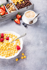 Healthy breakfast with cereal balls, fresh milk and berries, selective focus.