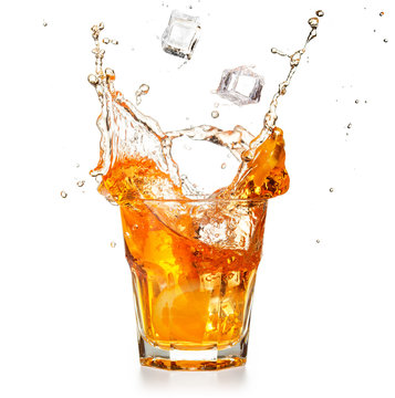 ice cubes falling into a splashing orange cocktail 