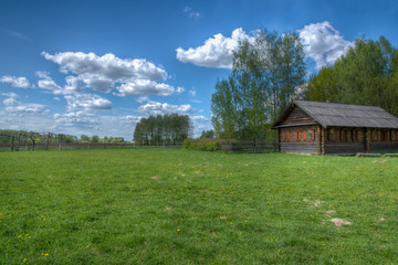 Green field with rustic cottage