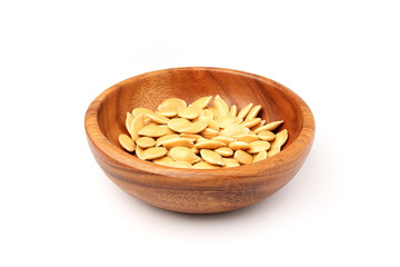 Pumpkin seeds in wooden plate.