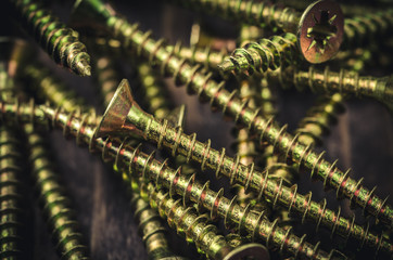 steel screws against a dark background/background from steel screws
