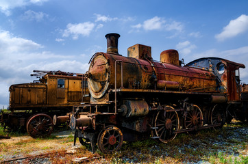 Fototapeta na wymiar Rusty old italian steam and electric locomotives 