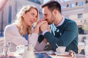 Romantic loving couple drinking coffee, having a date in the cafe. Dating, love, relationships