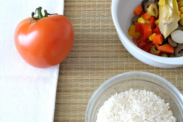 Top view of ingredient for Italian rice salad, traditional summer dish with rice, tomato, vegetables in oil