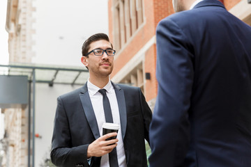 Two businessmen talking outdoors