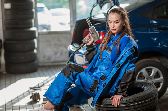 Young Beautiful Girl At An Auto Mechanic At Work