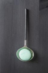 Traditional French sweets. Green mint macaroon. Black stone background.