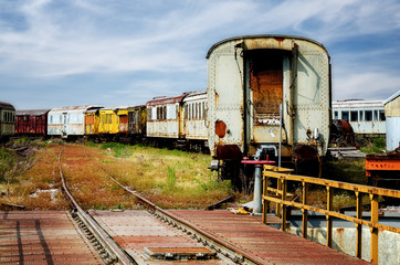 Fototapeta na wymiar old train station deposit with railway turntable and rusty railcars