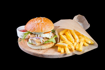Burger with french fries isolated on a black background