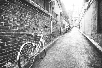 bicycle leaning against the wall on the background of the street