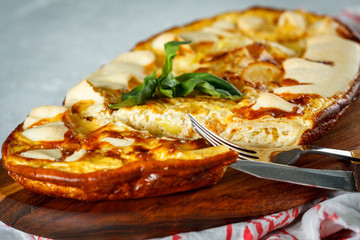 Sliced homemade tart with leek and cheese. French quiche.