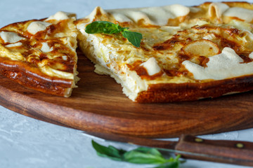 Sliced homemade tart with leek and cheese. French quiche.