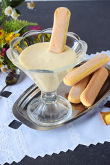 Cream for italian desert Tiramisu in a glass bowl with bisquits