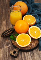 Jar of juice and fresh oranges