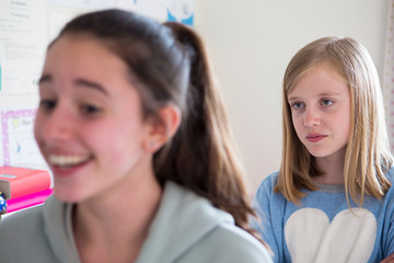 Young Girl Staring At Disliked Friend