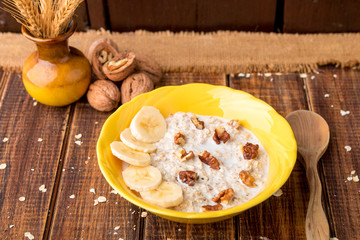 Healthy breakfast, bowl of granola with yogurt and fresh fruits on rustic background, top view
