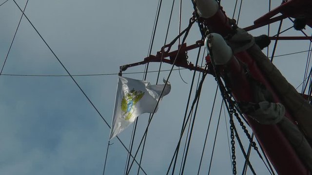 Murmansk, Russia - May 15, 2015: A triangular flag of the barque "Sedov" with the image
two-headed eagle flying in the wind against the blue sky. Editorial use.