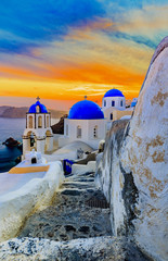 Picturesque view of Old Town Oia on the island Santorini, white houses, windmills and church with...