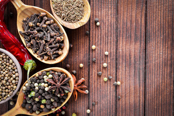 A mixture of spices. Wooden spoon. On Wooden background. Top view.