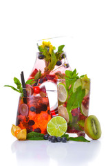 A fresh cocktail of tropical fruit and juice with ice. Fresh fruit lime, lemon, mint, kiwi. Top view. On a white background.