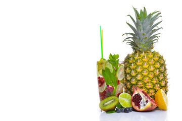 A fresh cocktail of tropical fruit and juice with ice. Fresh fruit lime, lemon, mint, kiwi. Top view. On a white background.