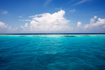 summer sea with blue water wave. Outdoor tropical summer sea paradise. Heaven view of deep transparent ocean. Sunshine reflection on a calm summer ocean. Tranquility of turquoise water