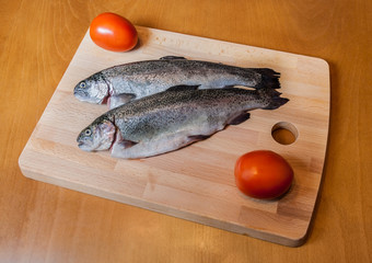 Fresh trout on wooden cutting board