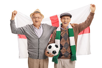 Excited elderly soccer fans with an English flag