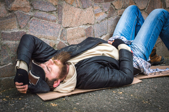 The homeless man is sleeping on the street
