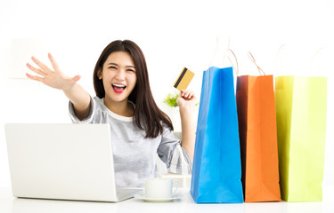 Young Woman showing credit card And Shopping Online.